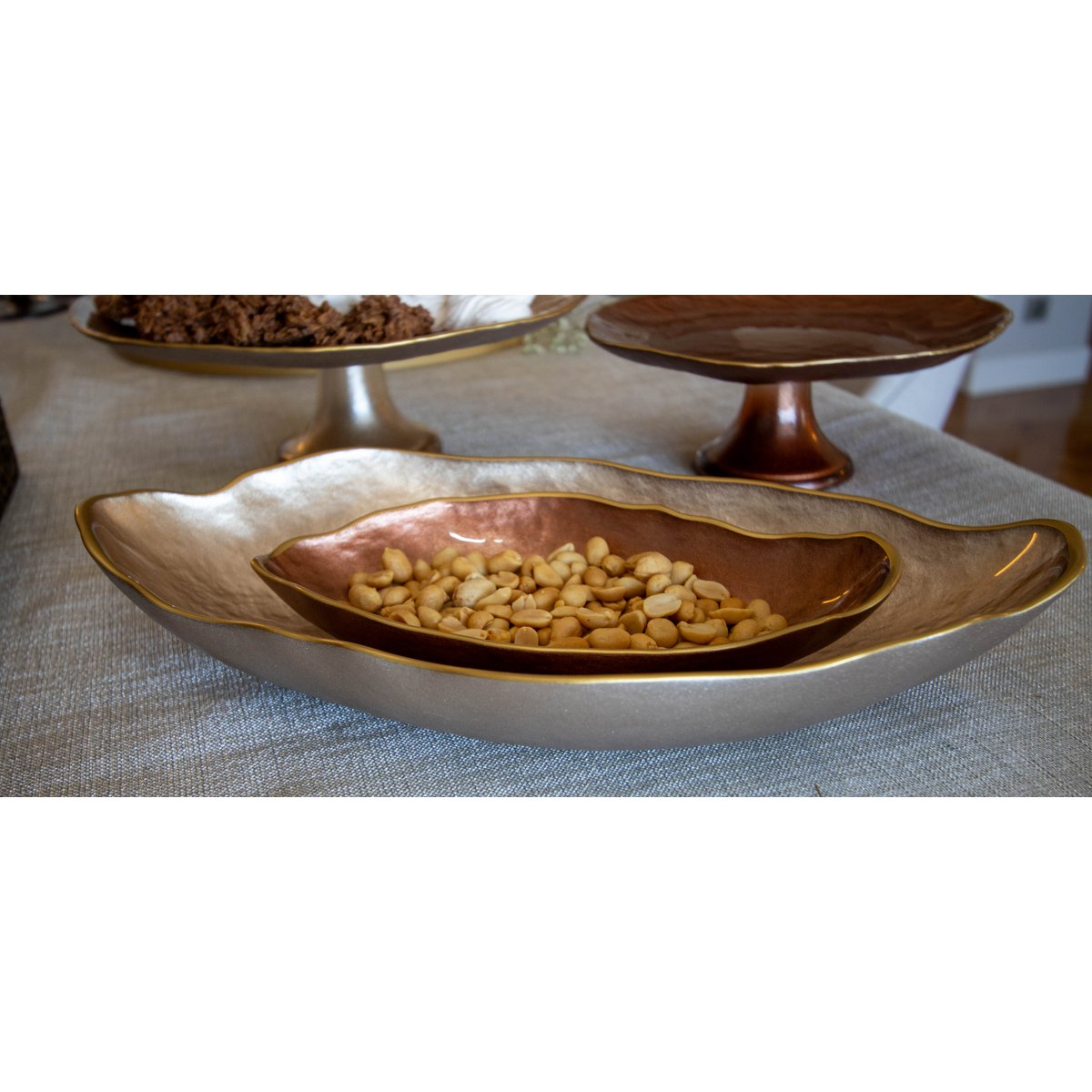 Decorative bowl with gold interior and exterior on a textured surface